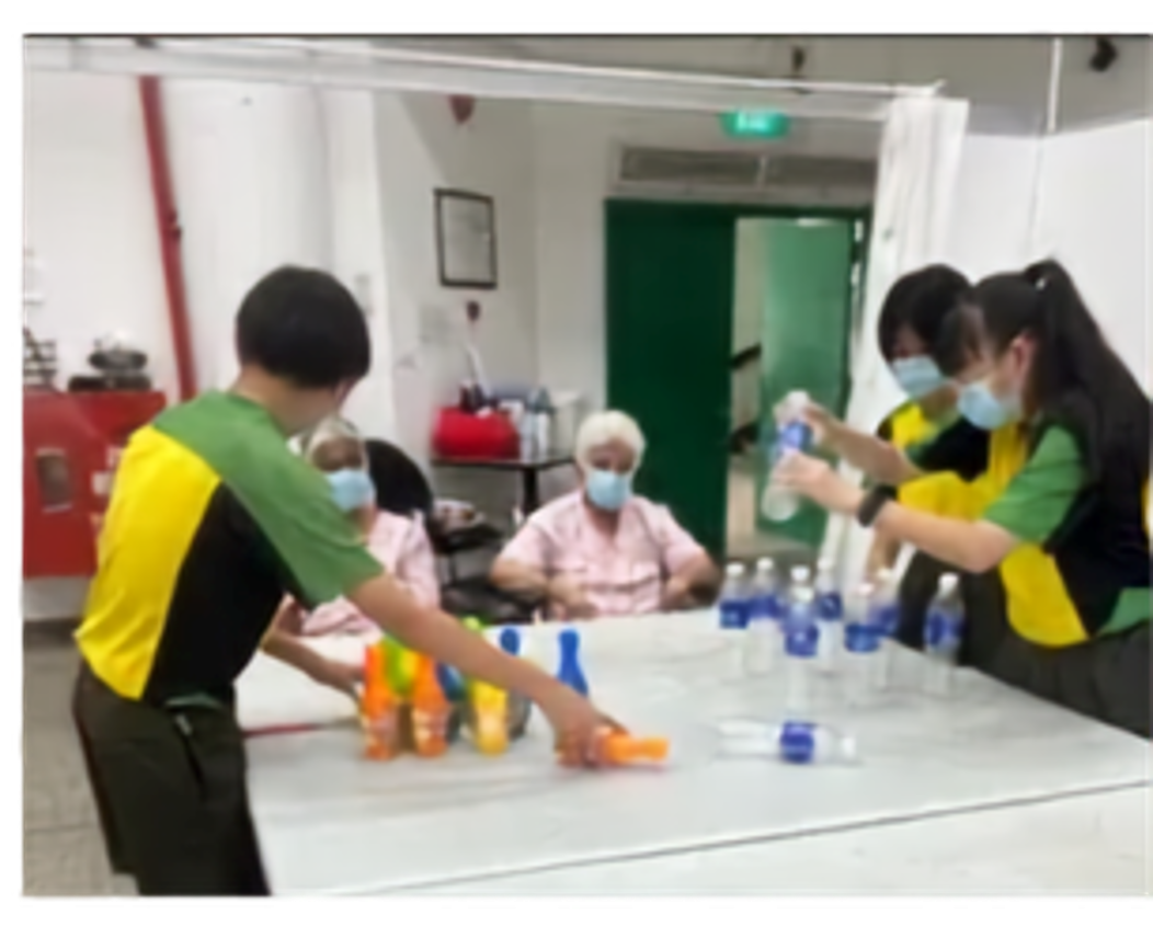 Secondary 2 students engaging in interactive games with the residents of Sree Narayan Mission Home, fostering intergenerational bonding and community spirit.